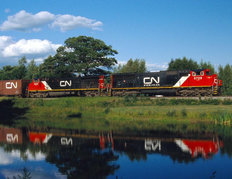 Two CN Locomotives in front of a Lake